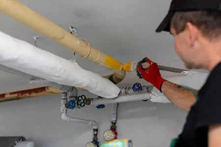 Plumber checking a homes main water pressure near the meter in wisconsin rapids